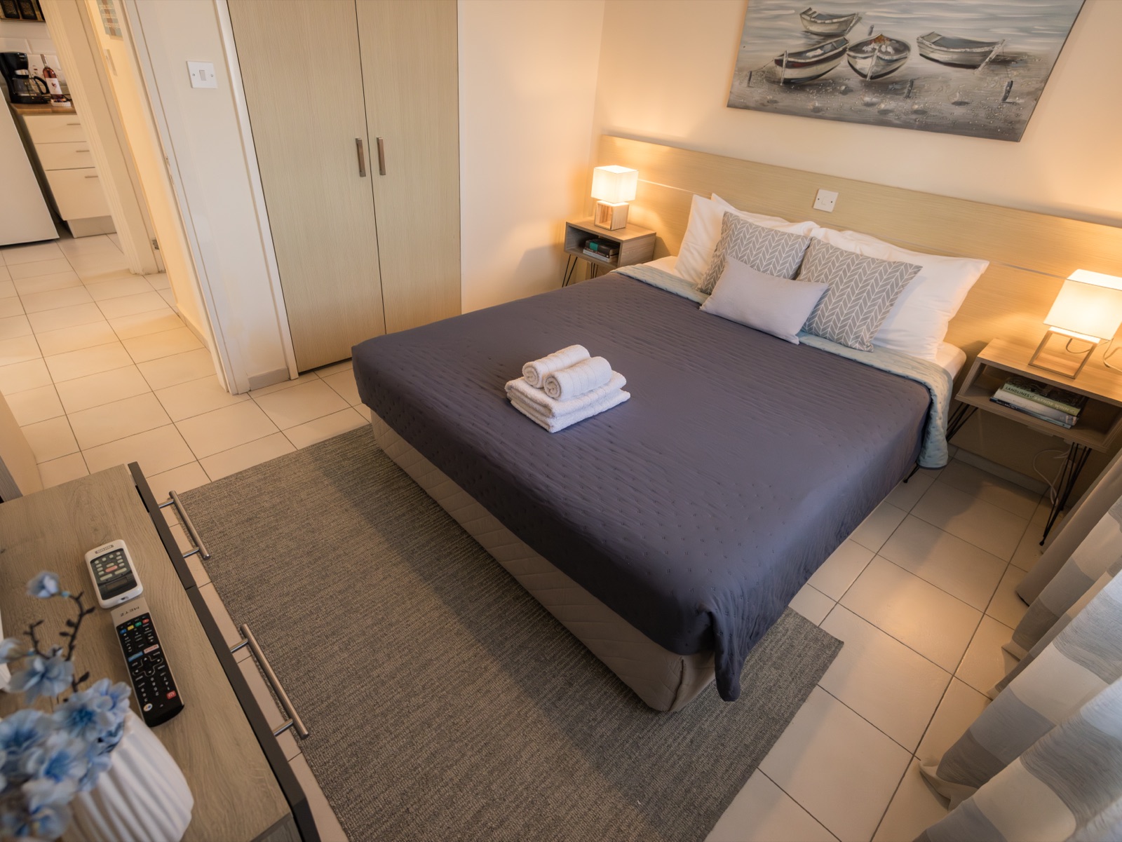 Bedroom with queen bed and fresh towels